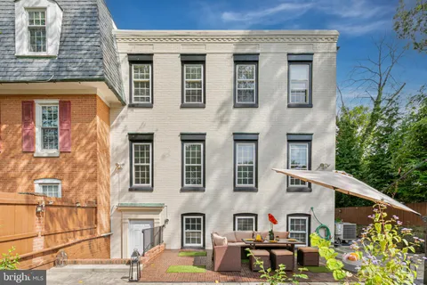 a front view of a house with garden and plants