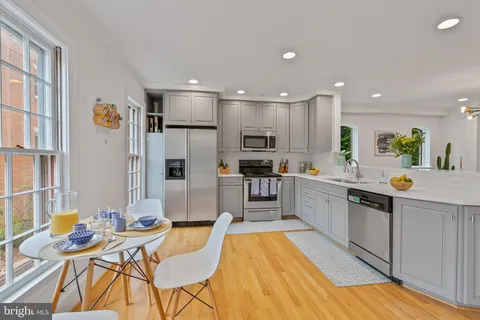 a kitchen with stainless steel appliances kitchen island granite countertop a sink and cabinets