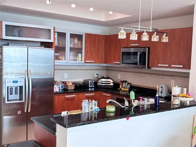 a kitchen with stainless steel appliances granite countertop a stove and a refrigerator