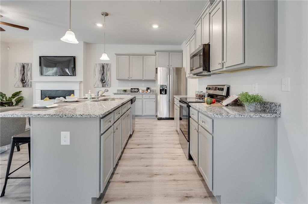 7437 Knoll Hollow Road Lithonia, GA 30058 - Photo 20 of 46 a kitchen with a sink stove and cabinets