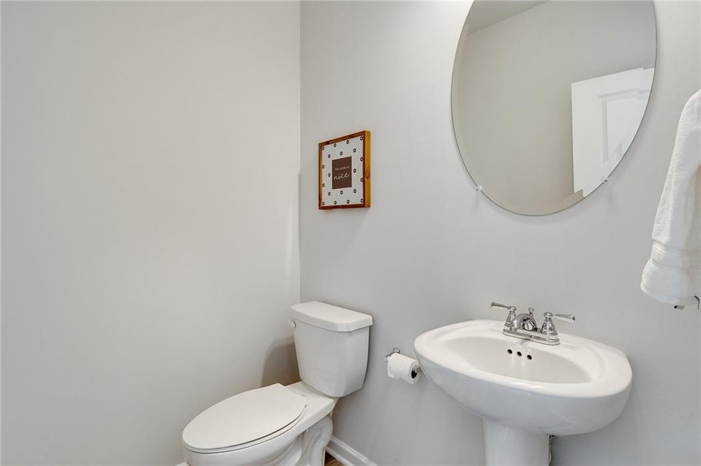 7437 Knoll Hollow Road Lithonia, GA 30058 - Photo 24 of 46 a bathroom with a toilet sink and mirror