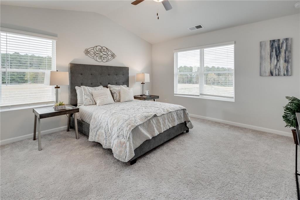 7437 Knoll Hollow Road Lithonia, GA 30058 - Photo 26 of 46 a bedroom with a bed lamp and window