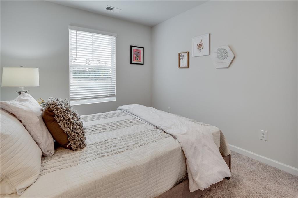 7437 Knoll Hollow Road Lithonia, GA 30058 - Photo 39 of 46 a bedroom with a bed and a window