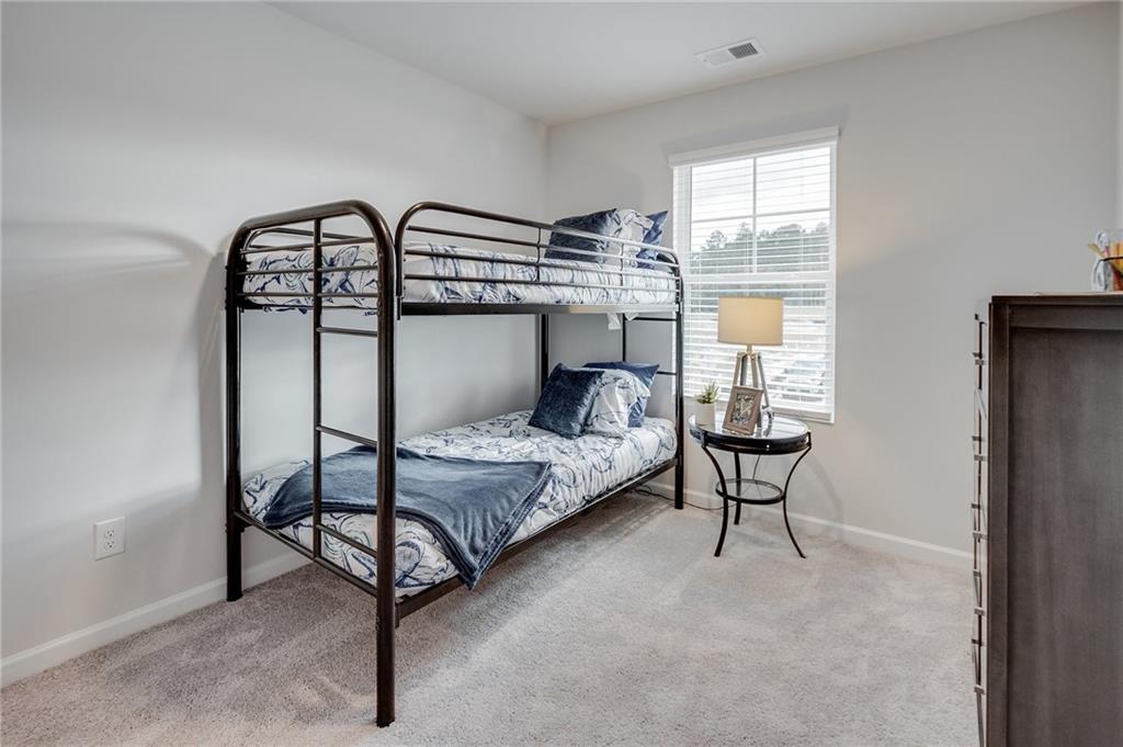 7437 Knoll Hollow Road Lithonia, GA 30058 - Photo 42 of 46 a bedroom with a bed a window and closet