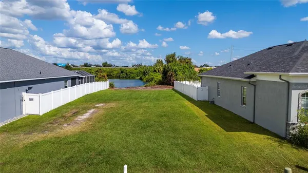 an aerial view of residential houses with outdoor space and swimming pool