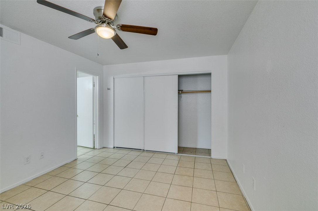 7570 West Flamingo Road, Unit 252 Las Vegas, NV 89147 - Photo 28 of 44 A well-lit bedroom offering tiled flooring and convenient closet storage.