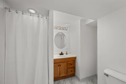 a bathroom with a sink a toilet and a mirror