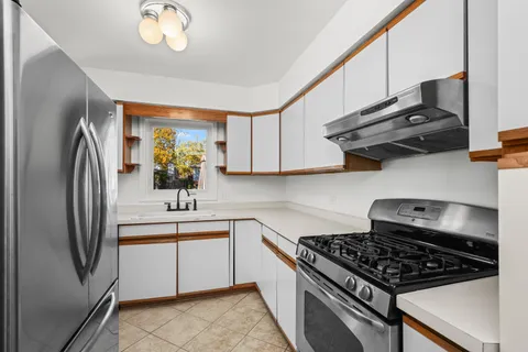 a kitchen with stainless steel appliances granite countertop a stove and a refrigerator