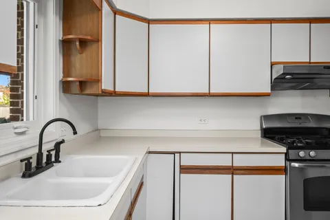 a kitchen with a sink and a stove top oven