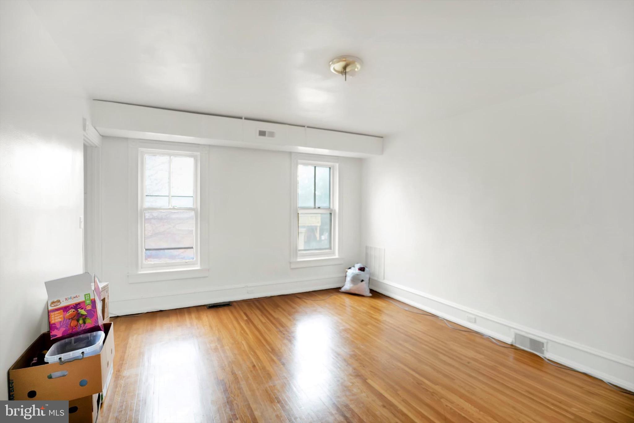 400 North 5th Street Reading, PA 19601 - Photo 11 of 25 an empty room with wooden floor and windows