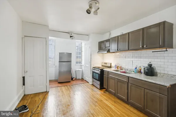a bedroom with a bed and a wooden floor