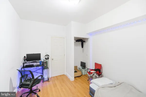 a view of a room with wooden floor and a window
