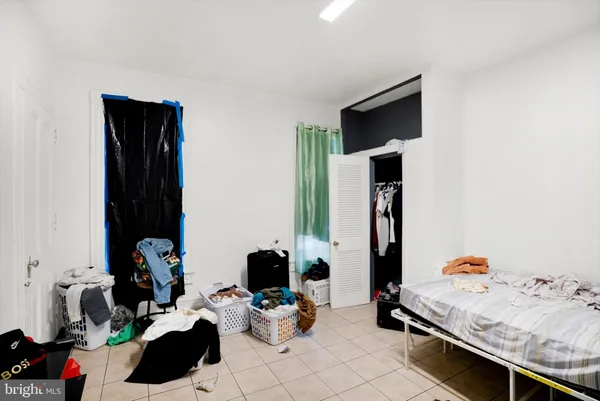 a bedroom with a bed and a tv in it