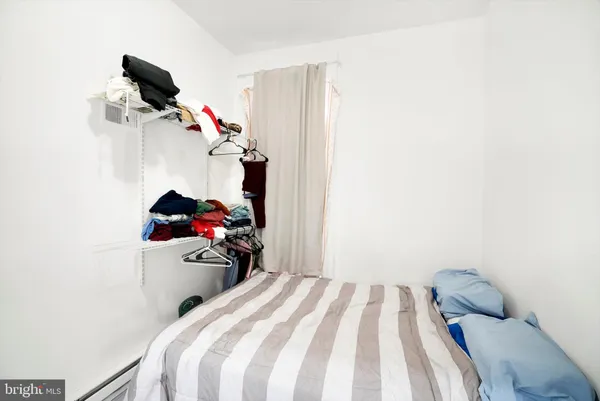 a room with furniture a flat screen tv and a window