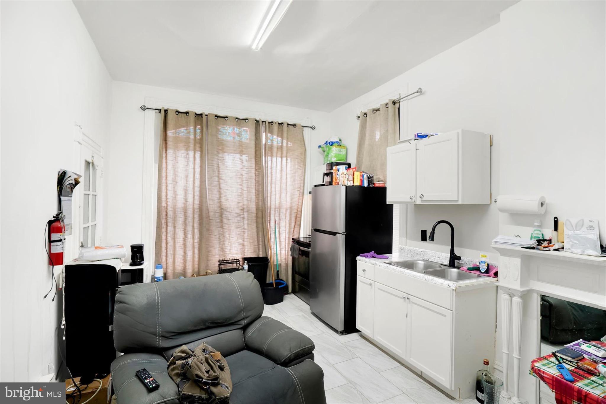 400 North 5th Street Reading, PA 19601 - Photo 7 of 25 a room with furniture a flat screen tv and a window