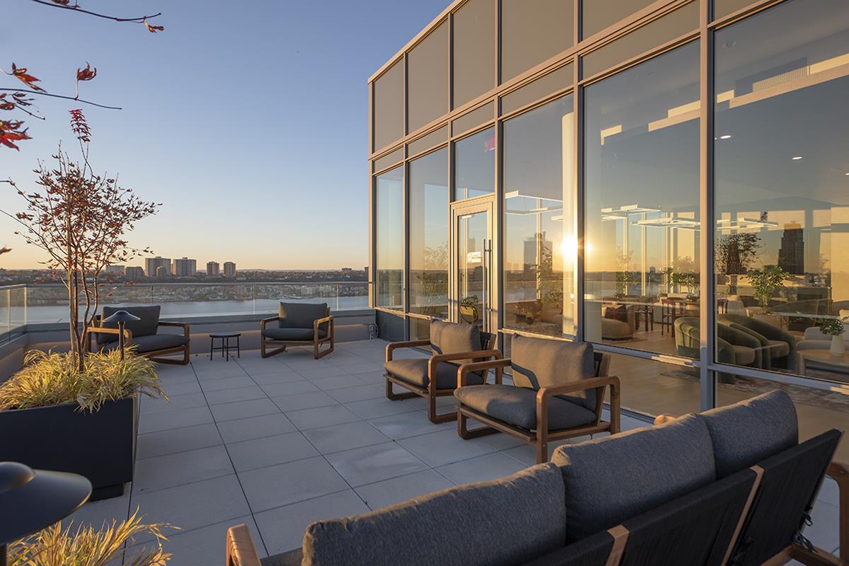 1440 Amsterdam Avenue, Unit 1617 Manhattan, NY 10027 - Photo 22 of 25 a living room with furniture and floor to ceiling window