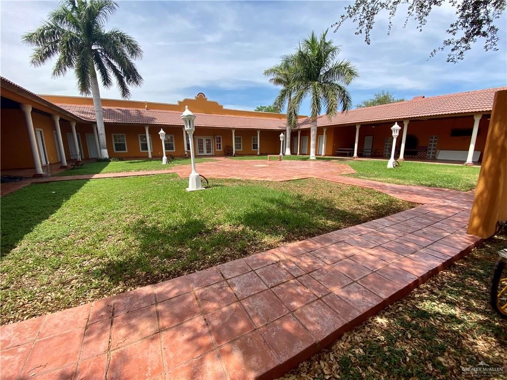 4113 Goodwin Road Mission, TX 78574 - Photo 8 of 14 a front view of a house with a garden and yard