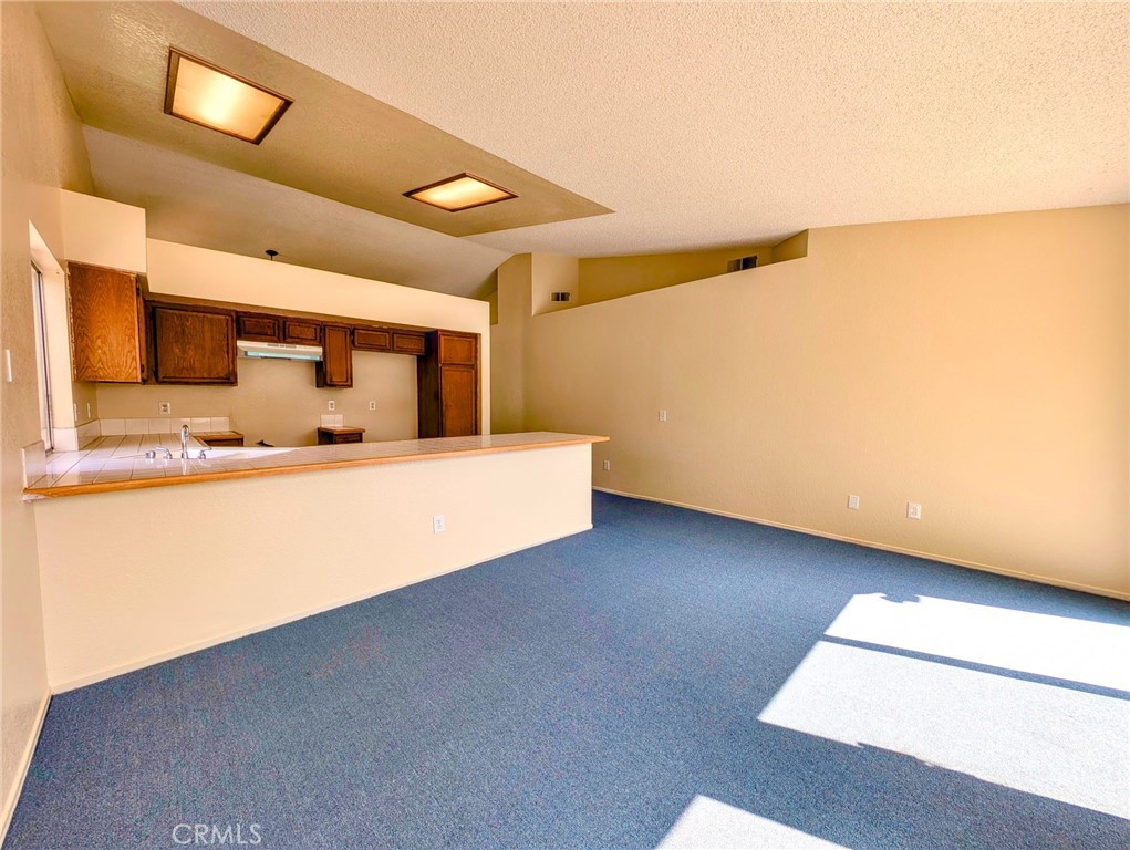 2795 Rosarita Street San Bernardino, CA 92407 - Photo 11 of 35 a living room with stainless steel appliances with kitchen island