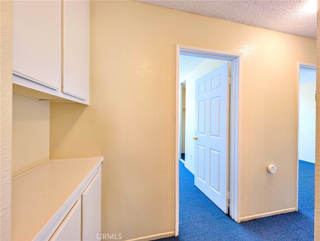 2795 Rosarita Street San Bernardino, CA 92407 - Photo 14 of 35 a view of a hallway with wooden floor
