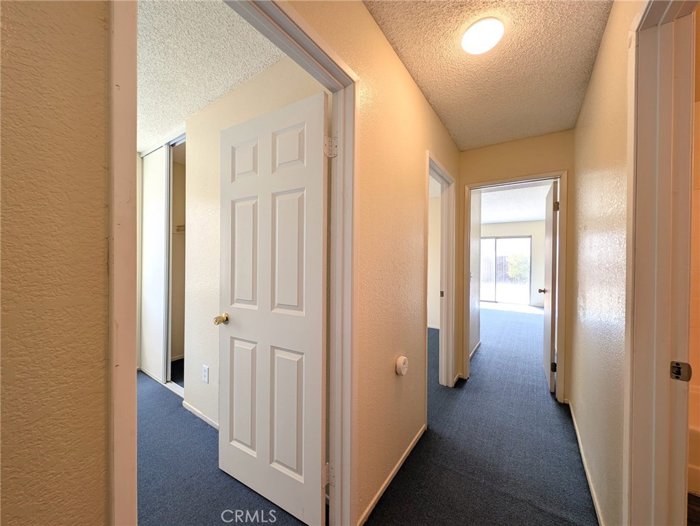 2795 Rosarita Street San Bernardino, CA 92407 - Photo 15 of 35 a view of a hallway with wooden floor