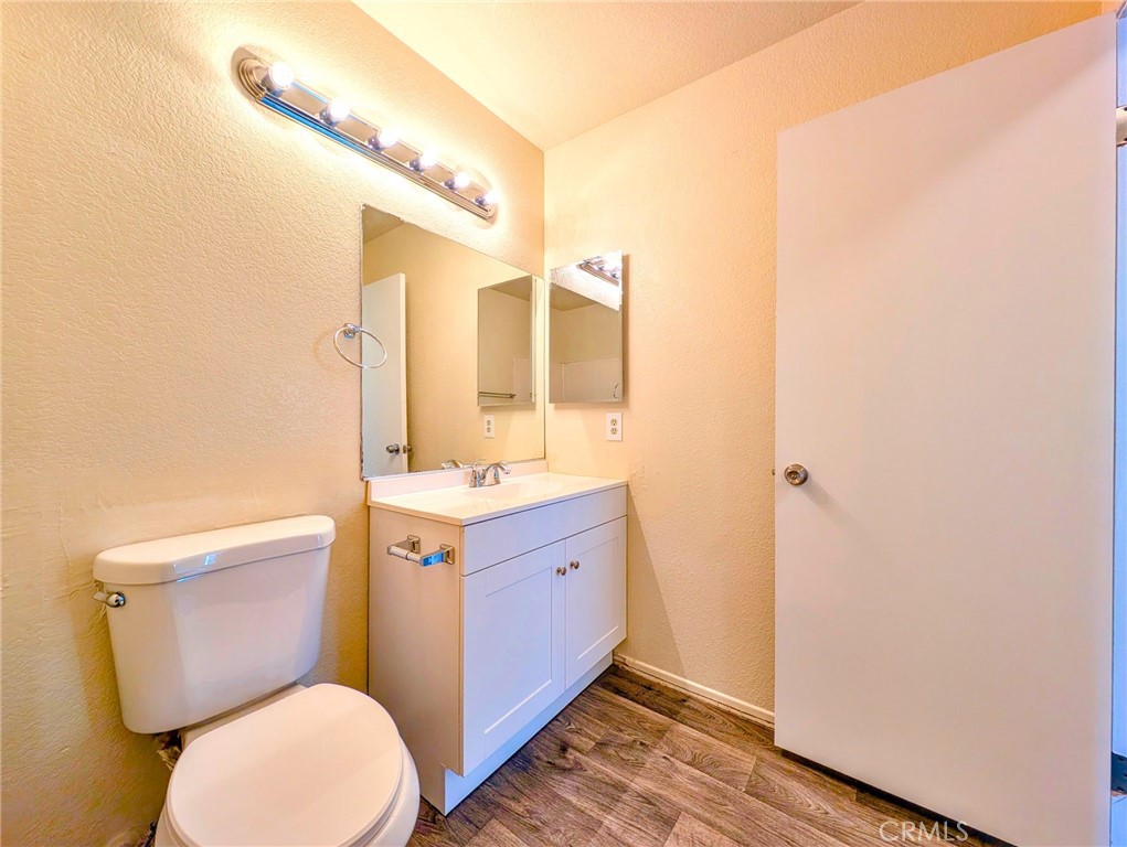 2795 Rosarita Street San Bernardino, CA 92407 - Photo 18 of 35 a bathroom with a granite countertop toilet sink and mirror