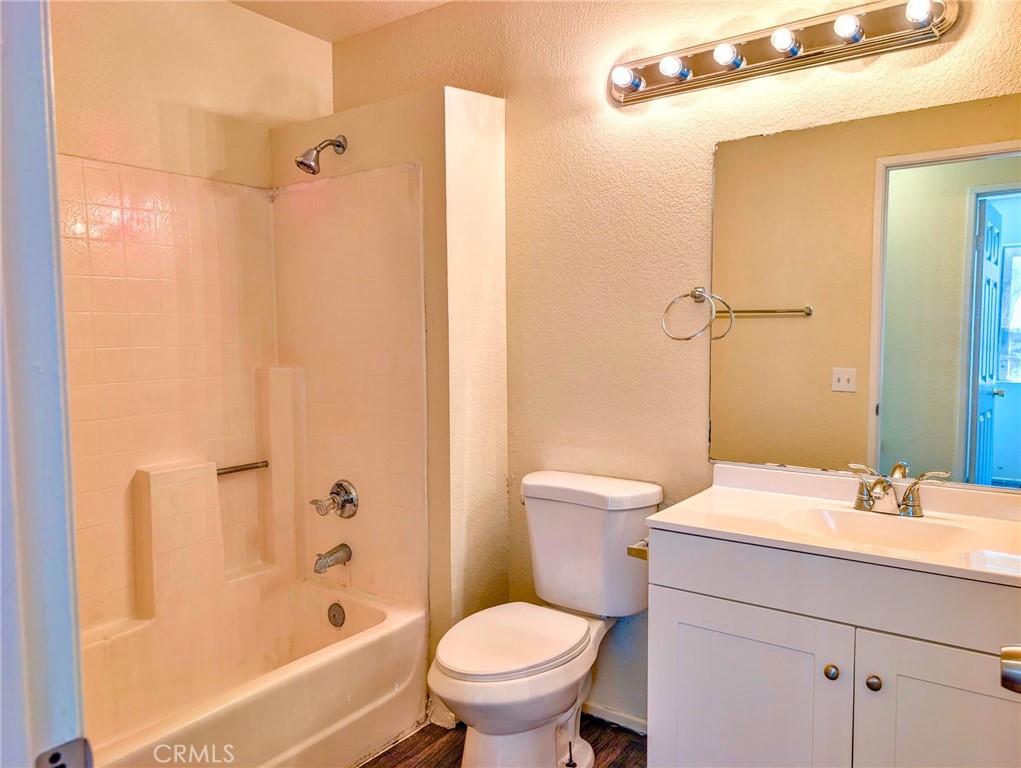 2795 Rosarita Street San Bernardino, CA 92407 - Photo 19 of 35 a bathroom with a sink a toilet and a bathtub