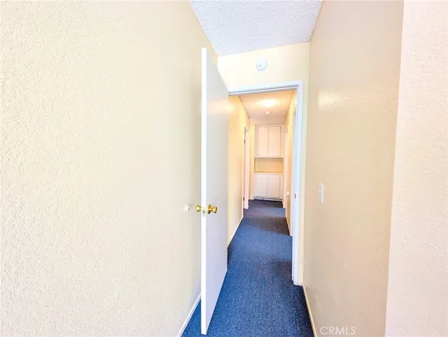 a view of a room with wooden floor and windows