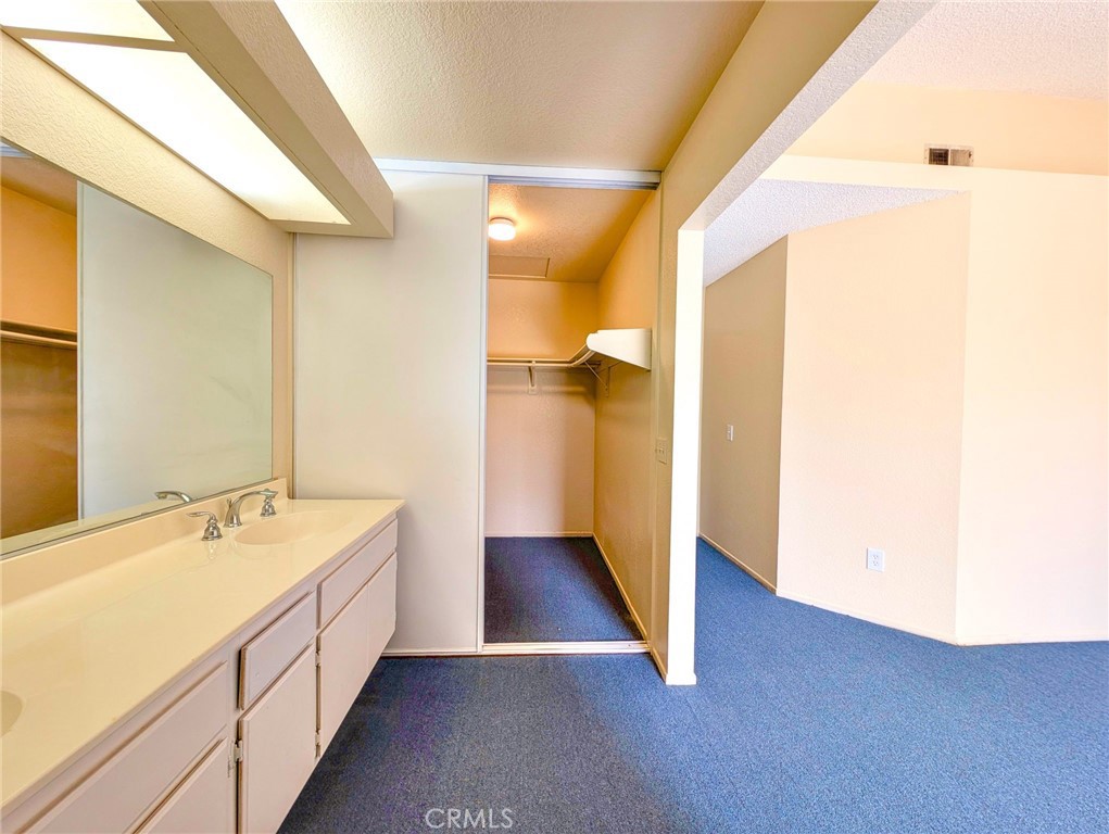 2795 Rosarita Street San Bernardino, CA 92407 - Photo 22 of 35 a bathroom with a double vanity sink and mirror