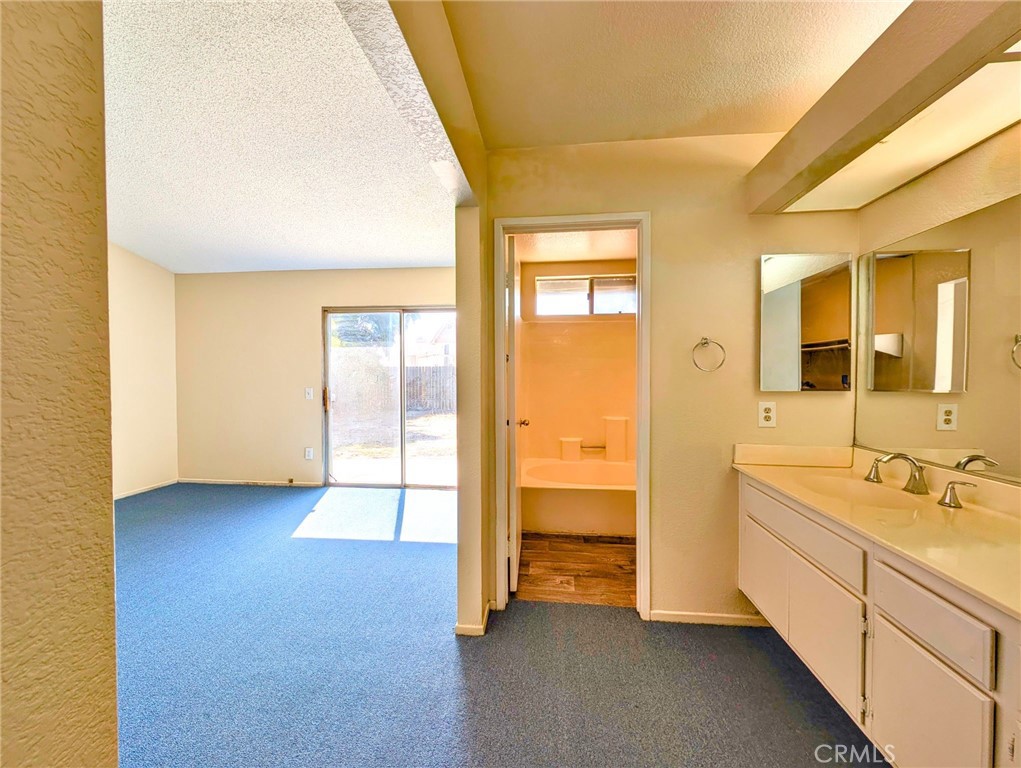 2795 Rosarita Street San Bernardino, CA 92407 - Photo 23 of 35 a bathroom with a sink and a mirror