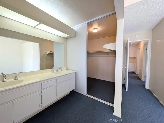 a spacious bathroom with a double vanity sink and a mirror