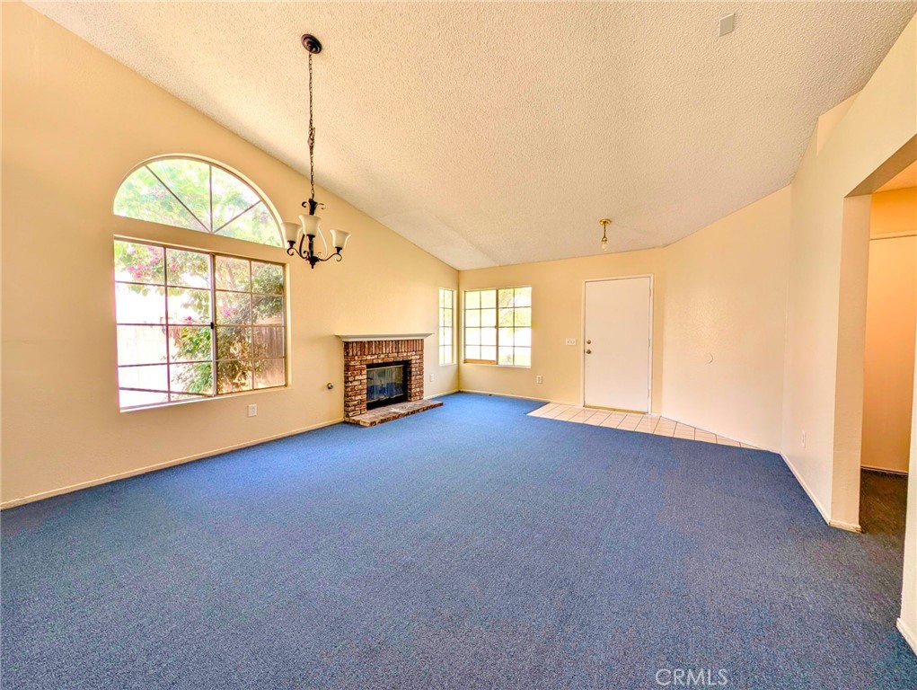 2795 Rosarita Street San Bernardino, CA 92407 - Photo 4 of 35 a view of empty room with fireplace and windows