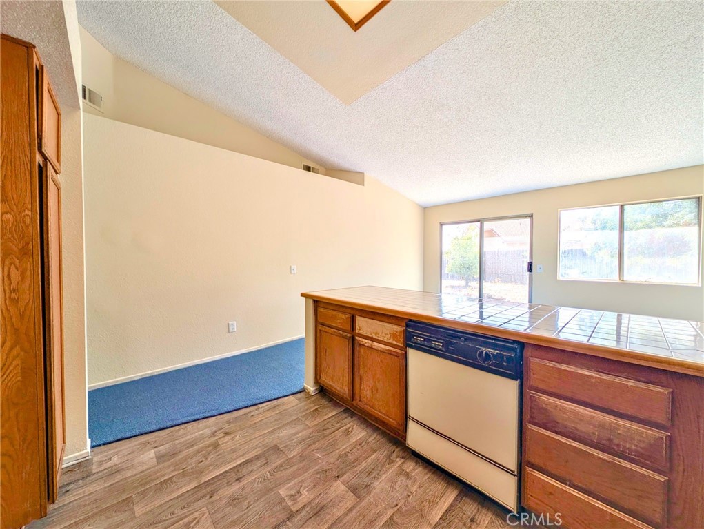 2795 Rosarita Street San Bernardino, CA 92407 - Photo 9 of 35 a view of a kitchen with wooden floor and a window