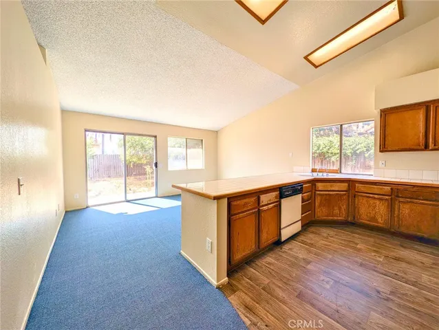 a living room with stainless steel appliances with kitchen island