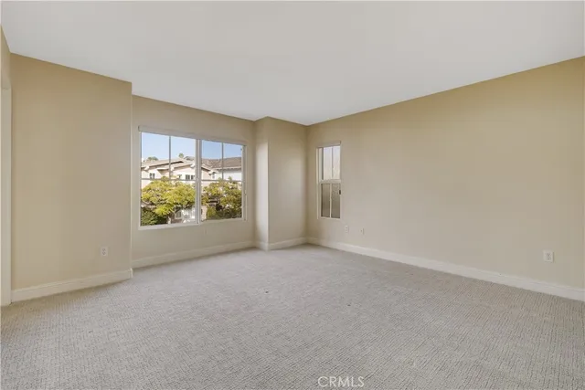 an empty room with windows and entrance