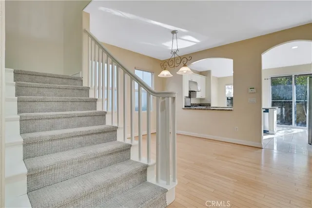a view of a hallway with wooden floor and staircase