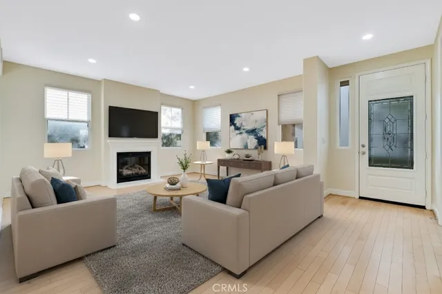 a living room with furniture a fireplace and a flat screen tv
