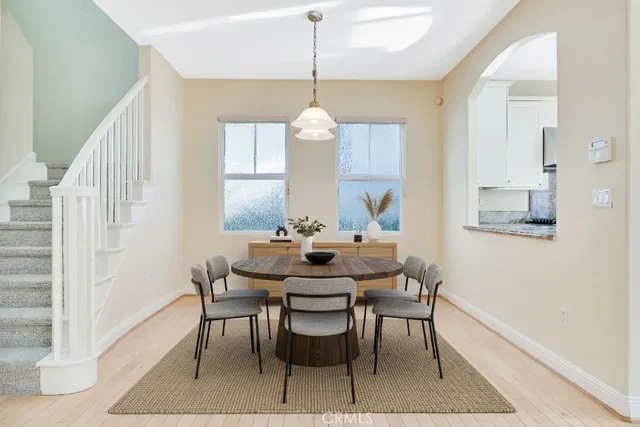 a dining room with furniture a chandelier and wooden floor