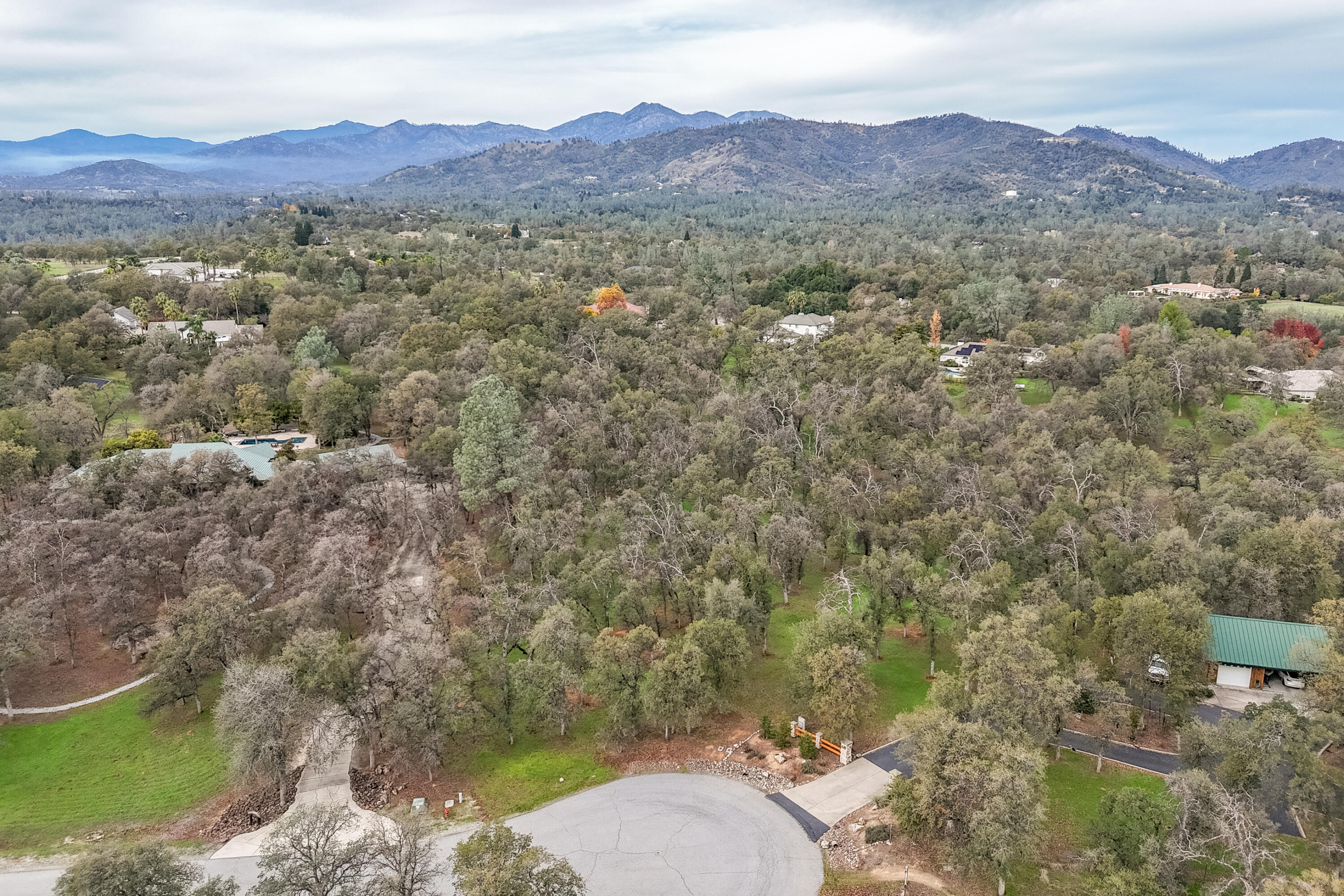 El Camino Robles Road Redding, CA 96001 - Photo 7 of 12 a view of a lush green hillside and a houses