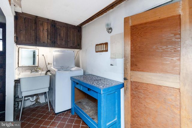 a kitchen with granite countertop a sink cabinets and stainless steel appliances