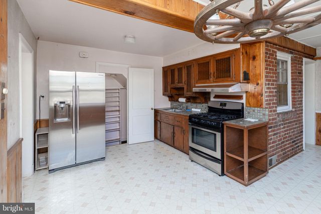 a kitchen with stainless steel appliances granite countertop a stove a refrigerator and a sink