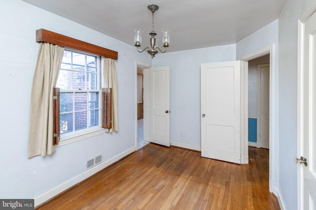 a view of a room with wooden floor and windows