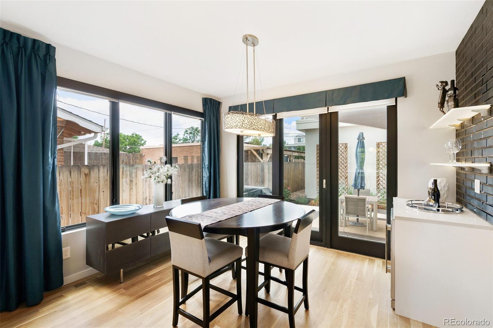 2145 King Street Denver, CO 80211 - Photo 12 of 40 a dining room with furniture large windows and a chandelier