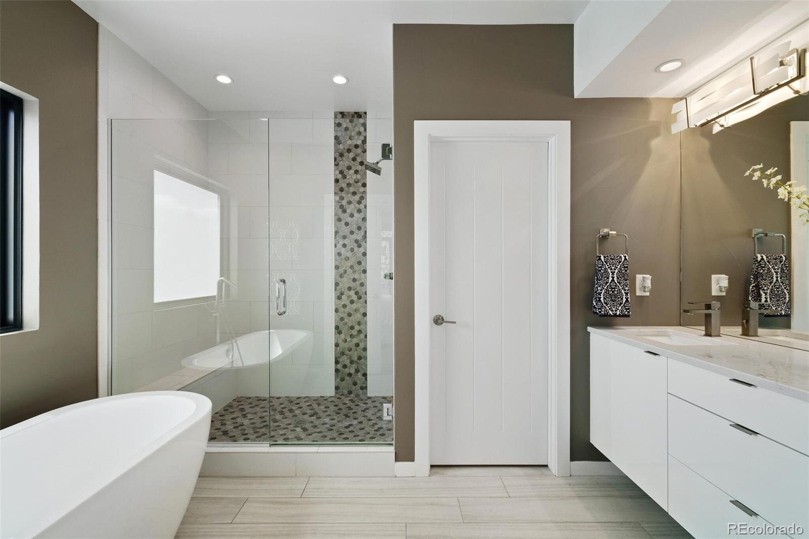 2145 King Street Denver, CO 80211 - Photo 17 of 40 a bathroom with a sink a toilet and shower