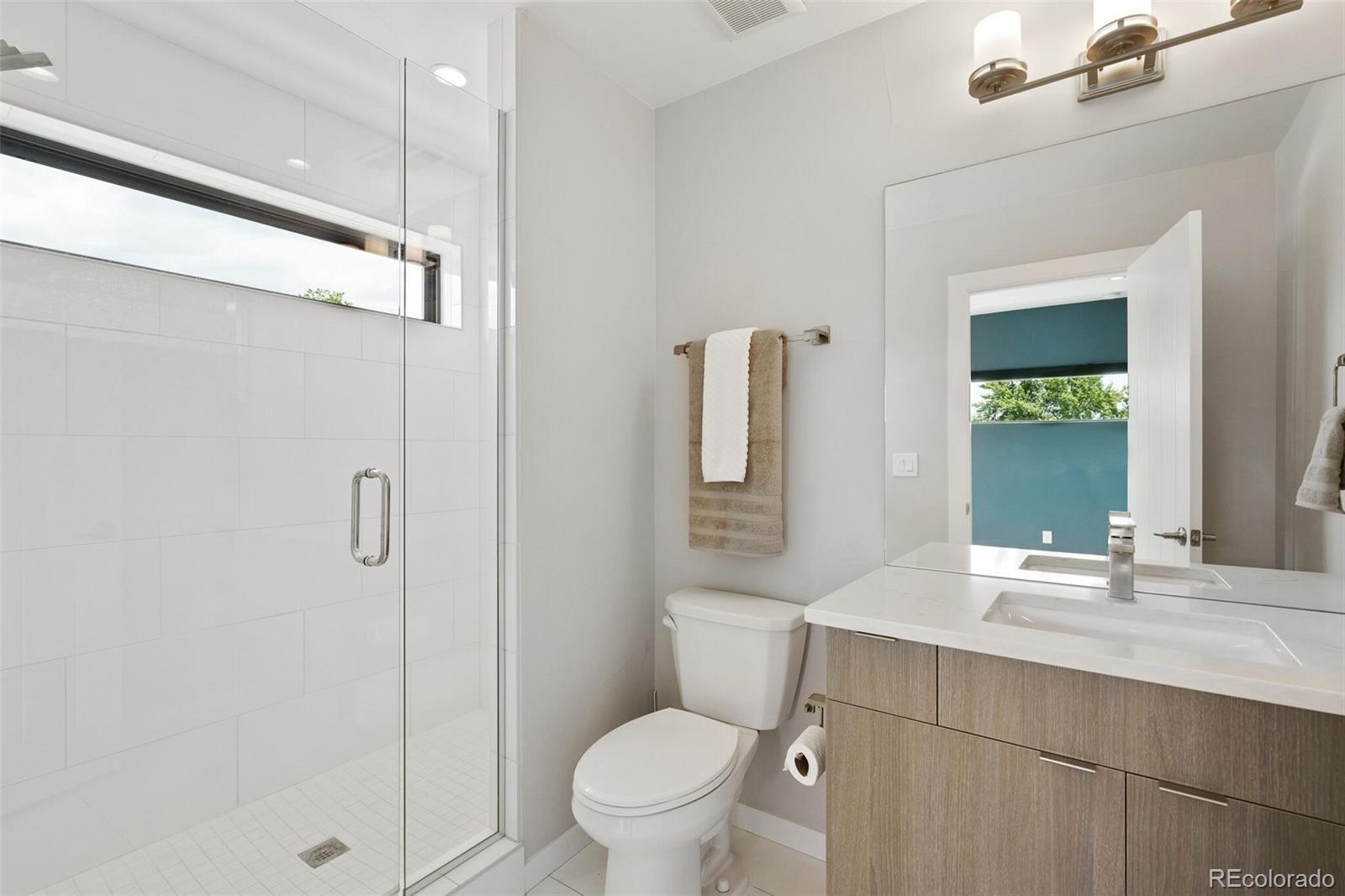 2145 King Street Denver, CO 80211 - Photo 21 of 40 a bathroom with a sink a toilet and shower