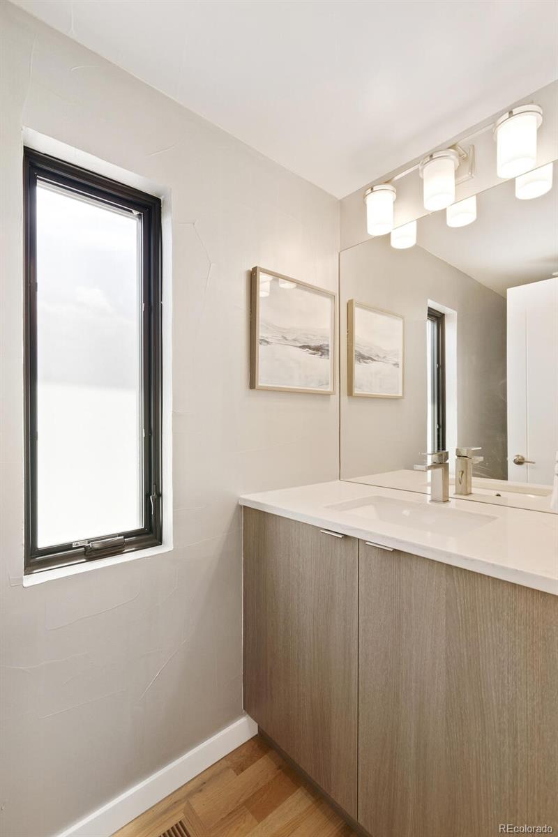 2145 King Street Denver, CO 80211 - Photo 26 of 40 a bathroom with a sink a vanity and a large mirror