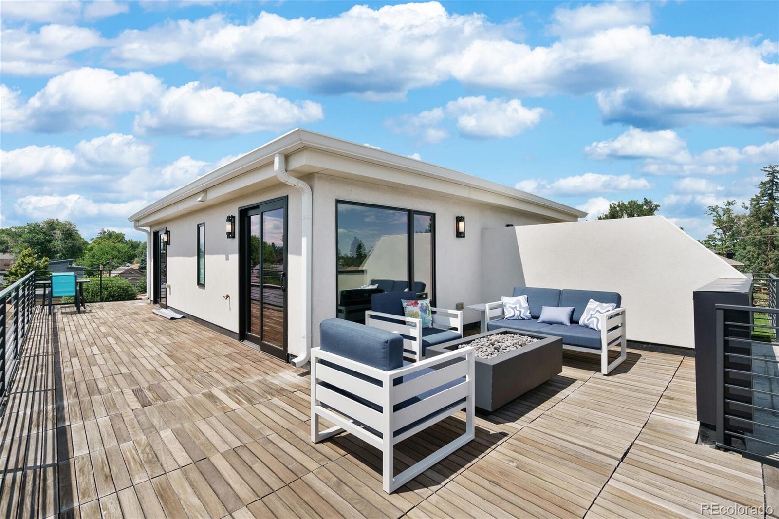 2145 King Street Denver, CO 80211 - Photo 27 of 40 a view of a roof deck with couches and sky view