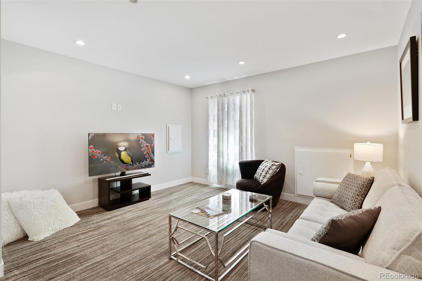 2145 King Street Denver, CO 80211 - Photo 29 of 40 a living room with furniture and a flat screen tv
