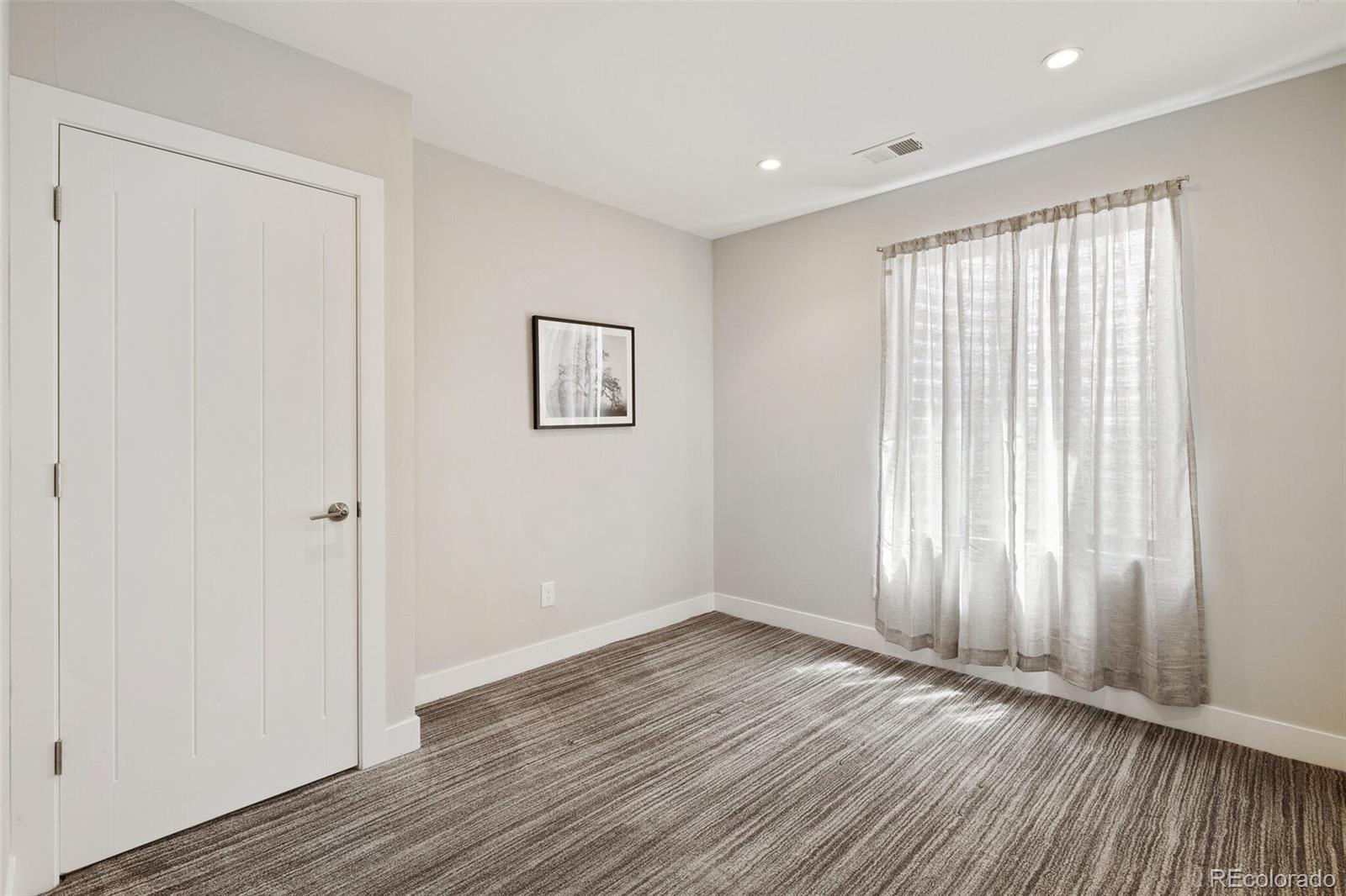 2145 King Street Denver, CO 80211 - Photo 32 of 40 an empty room with wooden floor and windows