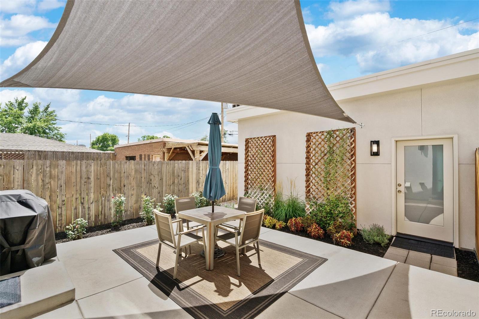 2145 King Street Denver, CO 80211 - Photo 34 of 40 a patio with table and chairs and potted plants