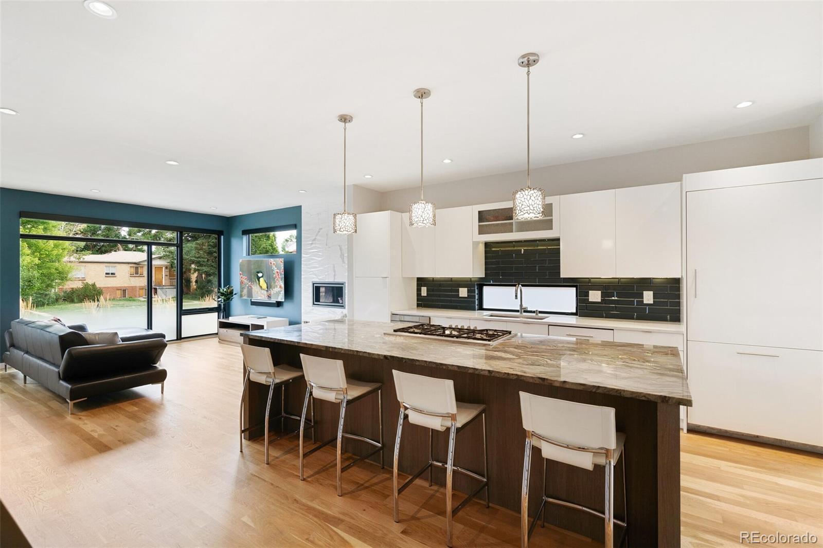 2145 King Street Denver, CO 80211 - Photo 6 of 40 a kitchen with stainless steel appliances granite countertop a stove a sink island and chairs